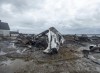 Debris from a burnt out fish plant is scattered along the shore in Middle West Pubnico, N.S. on Saturday, Oct. 17, 2020. A large fire destroyed a commercial building that was the scene of a confrontation earlier in the week between Indigenous and non-Indigenous fishermen. Tensions remain high over an Indigenous-led lobster fishery that has been the source of conflict. THE CANADIAN PRESS /Andrew Vaughan