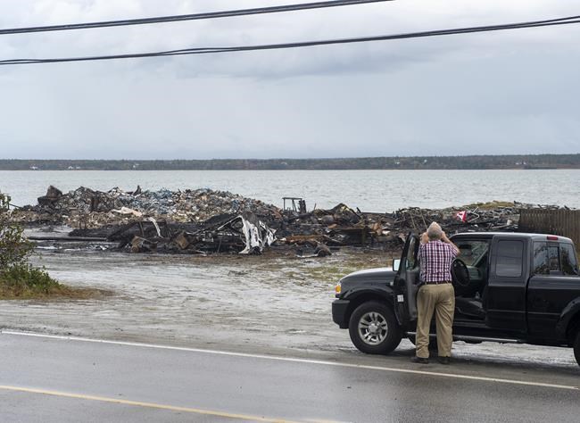 Debris from a burnt out fish plant is scattered along the shore in Middle West Pubnico, N.S. on Saturday, Oct. 17, 2020. A large fire destroyed a commercial building that was the scene of a confrontation earlier in the week between Indigenous and non-Indigenous fishermen.Tensions remain high over an Indigenous-led lobster fishery that has been the source of conflict. THE CANADIAN PRESS /Andrew Vaughan