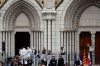 French police officers and forensic officers work on the scene of the knife attack in front of Notre Dame church, in Nice, France, Thursday, Oct. 29, 2020. An attacker armed with a knife killed three people at a church in the Mediterranean city of Nice, the third attack in two months in France. Prime Minister Justin Trudeau is condemning what he describes as a deadly terrorist attack in the French city of Nice. THE CANADIAN PRESS/AP/Daniel Cole