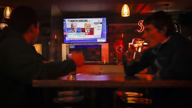 Patrons watch US election returns at The Unicorn bar in Calgary, Tuesday, Nov. 3, 2020.THE CANADIAN PRESS/Jeff McIntosh