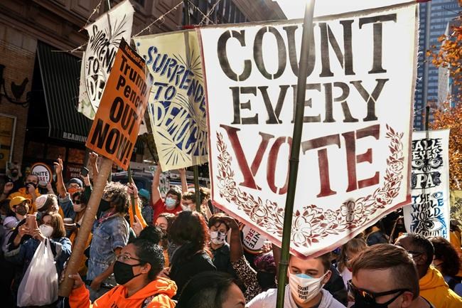 People urge for all votes to be counted as they demonstrate outside the Pennsylvania Convention Center where votes are being counted, Friday, Nov. 6, 2020, in Philadelphia. THE CANADIAN PRESS/AP/John Minchillo