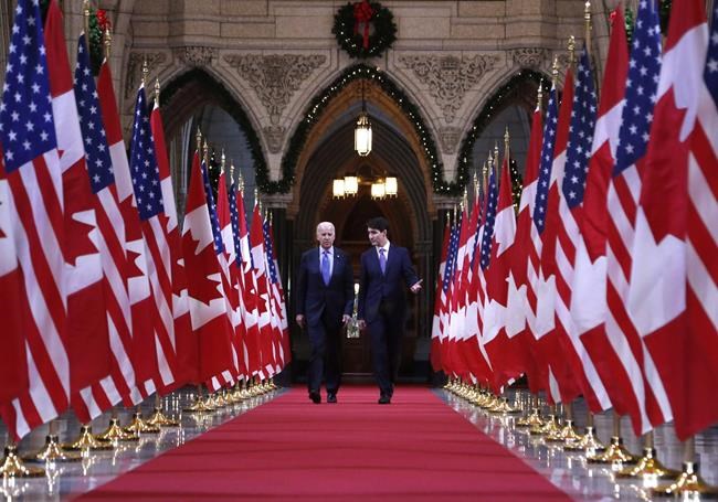 Prime Minister Justin Trudeau and US vice-president Joe Biden walk down the Hall of Honour on Parliament Hill in Ottawa on Friday, December 9, 2016. The election of Democrat Joe Biden as the next president of the United States is expected to have wide-ranging implications for Canadian politics and policy. THE CANADIAN PRESS/Patrick Doyle
