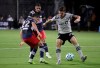 Montreal Impact defender Jukka Raitala, right, battles for the ball with New England Revolution midfielder Carles Gil, left, and midfielder Brandon Bye, center, during the first half of an MLS soccer match, Thursday, July 9, 2020, in Kissimmee, Fla. Impact captain Raitala has a simple message for his teammates as a difficult year comes to a close: we need one more win.&nbsp; THE CANADIAN PRESS/AP-John Raoux