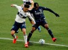 Vancouver Whitecaps defender Erik Godoy, left, and Los Angeles Galaxy midfielder Yony Gonzalez battle for possession during the first half of an MLS soccer match in Portland, Ore., Sunday, Nov. 8, 2020. THE CANADIAN PRESS/AP-Steve Dipaola
