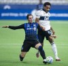 Vancouver Whitecaps forward Theo Bair (14) fights for control of the ball with Montreal Impact defender Luis Binks (5) during second half MLS soccer action in Vancouver, B.C., Wednesday, September, 16, 2020. The Impact have extended defender Binks' loan from Italy's Bologna through December 2021. THE CANADIAN PRESS/Jonathan Hayward