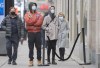 People wear face masks as they wait to enter a store in Montreal, Saturday, November 14, 2020, as the COVID-19 pandemic continues in Canada and around the world. THE CANADIAN PRESS/Graham Hughes