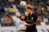 Nashville SC's Walker Zimmerman, right, heads the ball over Sporting Kansas City forward Gianluca Busio, left, during the first half of an MLS soccer match in Kansas City, Kan., Sunday, Oct. 11, 2020.&nbsp;Nashville SC centre back Walker Zimmerman has been named the 2020 MLS Defender of the Year. THE CANADIAN PRESS/AP-Orlin Wagner