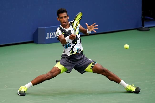 Felix Auger-Aliassime, of Canada, returns a shot to Dominic Thiem, of Austria, during the fourth round of the US Open tennis championships in New York on September 7, 2020. THE CANADIAN PRESS/AP, Seth Wenig