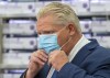 Ontario Premier Doug Ford puts his mask back on during the daily briefing at Humber River Hospital in Toronto on Tuesday November 24, 2020.&nbsp;Ford says he wants a clear delivery date for the province's share of COVID-19 vaccines, stressing that 