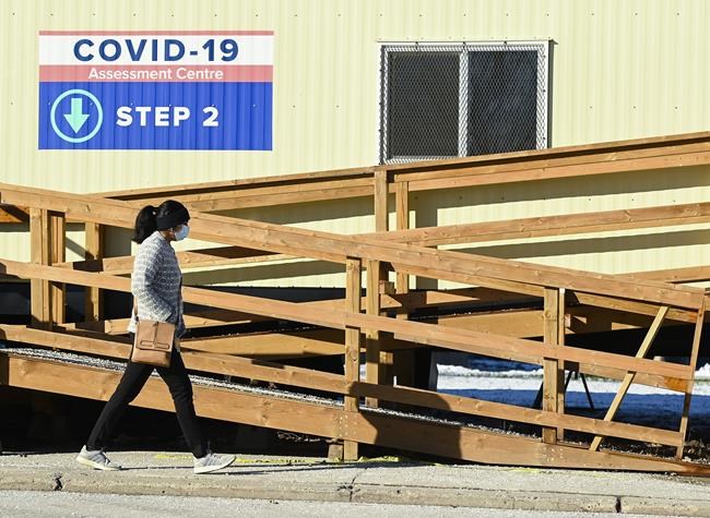 A person walks past a COVID-19 assessment centre during the COVID-19 pandemic in Scarborough, Ont., on Wednesday, December 2, 2020. Toronto and Peel region continue to be in lockdown. THE CANADIAN PRESS/Nathan Denette