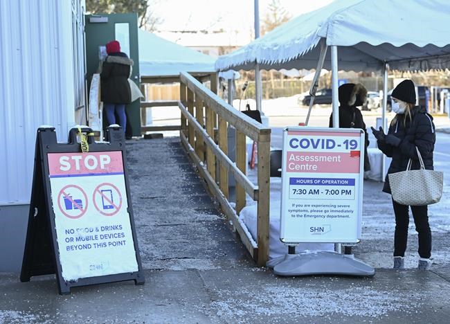 People line up at a COVID-19 assessment centre during the COVID-19 pandemic in Scarborough, Ont., on Wednesday, December 2, 2020. Toronto and Peel region continue to be in lockdown. THE CANADIAN PRESS/Nathan Denette