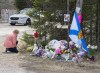 A woman pays her respects to victims of a mass shooting at a roadblock in Portapique, N.S. on Wednesday, April 22, 2020. THE CANADIAN PRESS/Andrew Vaughan