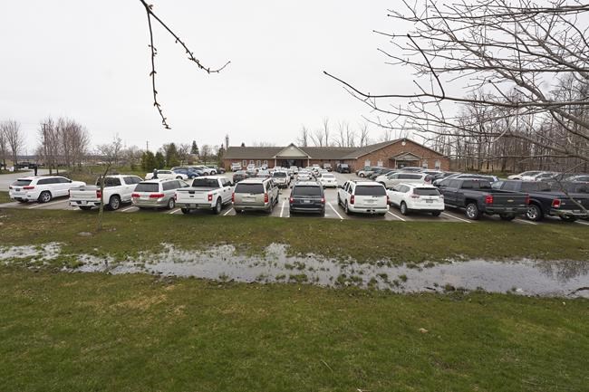Parishioners sit in their vehicles in the parking lot at The Church of God in Aylmer, Ont., Sunday, April 26, 2020. A church in Winnipeg, which has held drive-in services which they say pose no public health risk, is fighting a provincial ban on in-person religious services. THE CANADIAN PRESS/Geoff Robins