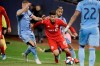 Toronto FC's Alejandro Pozuelo, in red, fights for control of the ball with New York City FC's Maximiliano Moralez, back right, and Alexander Ring during second half MLS Eastern Conference semifinal soccer action, in New York, Wednesday, Oct. 23, 2019. Pozuelo has became just the second Toronto FC player to be named MLS MVP. THE CANADIAN PRESS/AP, Frank Franklin II