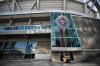 A worker cleans windows and doors at B.C. Place stadium, where Major League Soccer's Vancouver Whitecaps play their home games, in Vancouver, on Thursday, March 12, 2020. A former coach for the Vancouver Whitecaps and Canada Soccer's women's teams has been charged with sexual offences involving four people. THE CANADIAN PRESS/Darryl Dyck