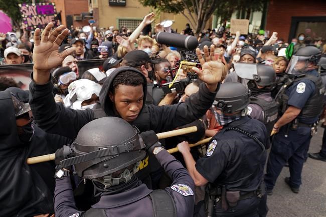 Police and protesters converge during a demonstration on Wednesday, Sept. 23, 2020, in Louisville, Ky. Demonstrations around the world called for accountability and transparency after police shootings and other officer-involved deaths in the United States over the summer. THE CANADIAN PRESS/AP, John Minchillo