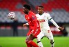 Bayern's Alphonso Davies, left, controls the ball in front of Lokomotiv's Francois Kamano, right, during the Champions League Group A soccer match between Bayern Munich and Lokomotiv Moscow at the Allianz Arena in Munich, Germany, Wednesday, Dec. 9, 2020. THE CANADIAN PRESS/AP-Matthias Schrader