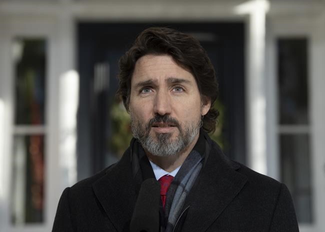 Prime Minister Justin Trudeau delivers his opening remarks during a news conference outside Rideau Cottage in Ottawa, Friday, December 18, 2020. THE CANADIAN PRESS/Adrian Wyld