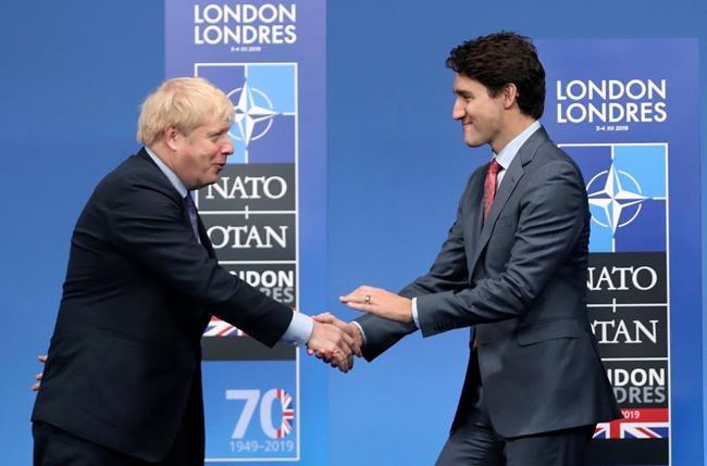 In this Wednesday, Dec. 4, 2019 file photo, British Prime Minister Boris Johnson, left, welcomes Canadian Prime Minister Justin Trudeau during official arrivals for a NATO leaders meeting at The Grove hotel and resort in Watford, Hertfordshire, England. THE CANADIAN PRESS/AP-Francisco Seco