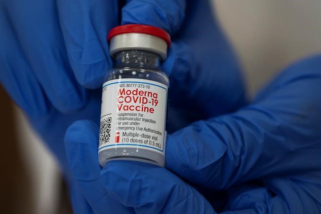 Michelle Chester, director of employee health services at Northwell Health, holds a bottle containing the Moderna COVID-19 vaccine at Northwell Health's Long Island Jewish Valley Stream hospital in Valley Stream, N.Y., on Monday, Dec. 21, 2020. THE CANADIAN PRESS/Eduardo Munoz/Pool via AP