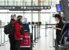 People wearing protective equipment check in at the international departures at Pearson International Airport during the COVID-19 pandemic in Toronto on Monday, December 14, 2020. THE CANADIAN PRESS/Nathan Denette