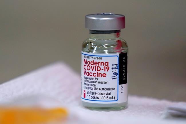A bottle of Moderna's COVID-19 vaccine is seen on a table on Wednesday, Dec. 30, 2020, in Topeka, Kan. The territory of Nunavut has received the vaccine and is to begin inoculating its elders on Wednesday. THE CANADIAN PRESS/AP/Charlie Riedel