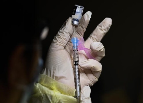 A registered pharmacist technician carefully fills the Pfizer-BioNTech COVID-19 mRNA vaccine at a vaccine clinic during the COVID-19 pandemic in Toronto on December 15, 2020. THE CANADIAN PRESS/Nathan Denette