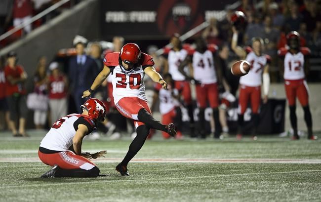 Calgary Stampeders kicker Rene Paredes, makes the winning kick as teammate Rob Maver holds the ball during second half CFL action against the Ottawa Redblacks in Ottawa on July 25, 2019. THE CANADIAN PRESS/Sean Kilpatrick