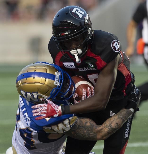 Winnipeg Blue Bombers' Mike Miller, left, tackles Ottawa Redblacks wide receiver Ryan Lankford during second quarter CFL action in Ottawa, Friday, July 5, 2019. The Blue Bombers have signed Canadian special-teams standout Miller to a one-year extension.THE CANADIAN PRESS/Adrian Wyld