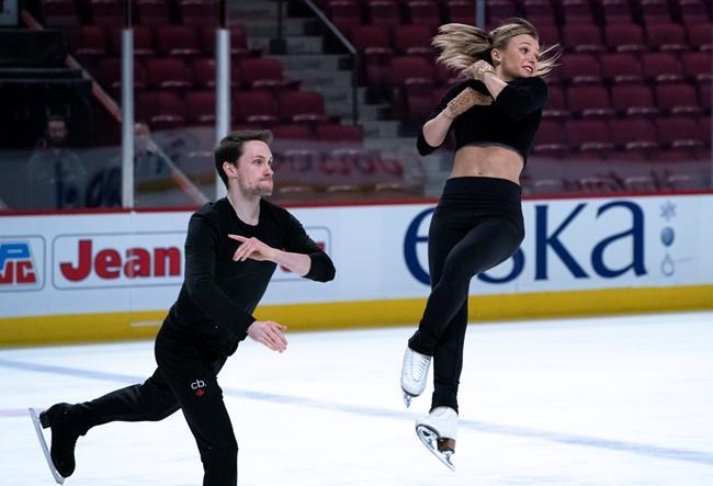 Canadian pairs Kirsten Moore-Towers is thrown by her partner Michael Marinaro during a practice in Montreal, on Monday, February 24, 2020. THE CANADIAN PRESS/Paul Chiasson