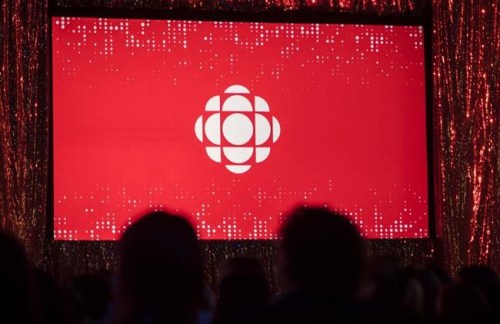 The CBC logo is projected onto a screen during the CBC's annual upfront presentation at The Mattamy Athletic Centre in Toronto, Wednesday, May 29, 2019. Canada's telecommunications regulator will launch a multi-day review today of the Canadian Broadcasting Corp.'s broadcasting licences. The CRTC says electronic hearings will begin at 10 a.m. before its five-member panel. THE CANADIAN PRESS/Tijana Martin