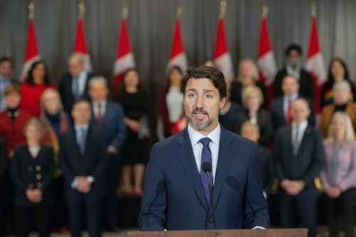 Prime Minister Justin Trudeau stands in front of his cabinet as he speaks to media during the final day of the Liberal cabinet retreat at the Fairmont Hotel in Winnipeg, Tuesday, Jan. 21, 2020. THE CANADIAN PRESS/Mike Sudoma