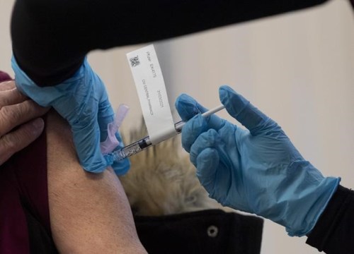 The Pfizer-BioNTech COVID-19 vaccine is administered to a personal support worker at the Ottawa Hospital Tuesday December 15, 2020 in Ottawa. THE CANADIAN PRESS/Adrian Wyld