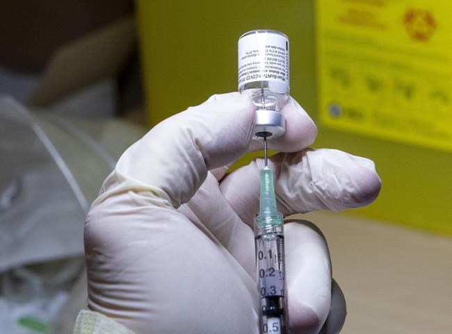 A Pfizer-BioNTech COVID-19 vaccine dose is prepared at The Michener Institute in Toronto on Monday, Dec. 14, 2020. Canada's COVID-19 vaccine rollout hits its one-month mark on Thursday, but questions remain about the inoculations themselves, how they're being distributed and what happens next.THE CANADIAN PRESS/Frank Gunn