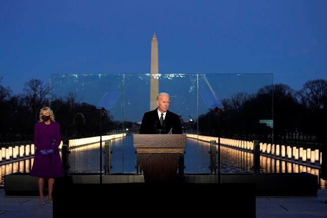 President-elect Joe Biden speaks during a COVID-19 memorial, with lights placed around the Lincoln Memorial Reflecting Pool, Tuesday, Jan. 19, 2021, in Washington. (AP Photo/Alex Brandon)