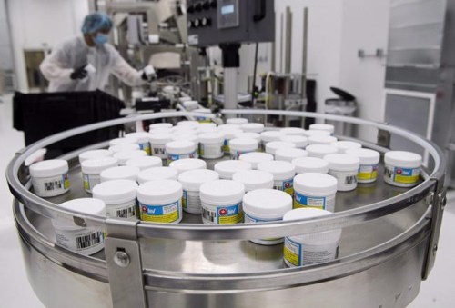 CannTrust employees work with cannabis products at their packaging and extraction facility in Vaughan, Ont., on Wednesday, Dec. 19, 2018. CannTrust Holdings Inc. says it will create a $50-million trust to settle claims from class action lawsuits filed after the company was found growing cannabis in unlicensed rooms two years ago. THE CANADIAN PRESS/Nathan Denette