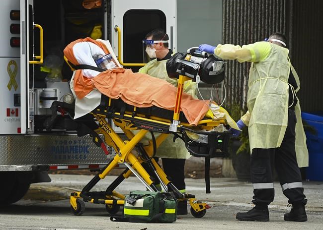 Paramedics take away an elderly patient at the Tendercare Living Centre, long-term-care facility during the COVID-19 pandemic in Scarborough, Ont., on Wednesday, December 23, 2020. THE CANADIAN PRESS/Nathan Denette