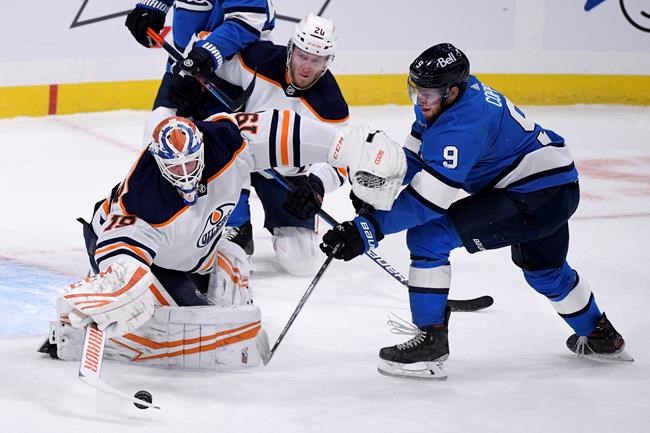 Edmonton Oilers goaltender Mikko Koskinen (19) makes a save on Winnipeg Jets' Andrew Copp (9) during first period NHL action in Winnipeg on Sunday Jan. 24, 2021. THE CANADIAN PRESS/Fred Greenslade
