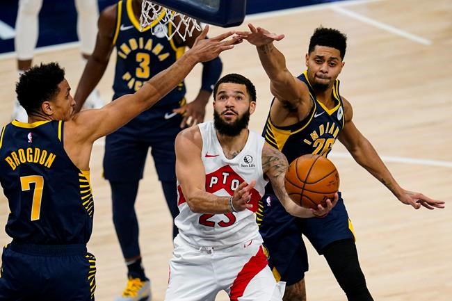 Toronto Raptors guard Fred VanVleet (23) goes under Indiana Pacers guards Malcolm Brogdon (7) and Jeremy Lamb (26) to shoot during the second half of an NBA basketball game in Indianapolis, Monday, Jan. 25, 2021. THE CANADIAN PRESS/AP-Michael Conroy