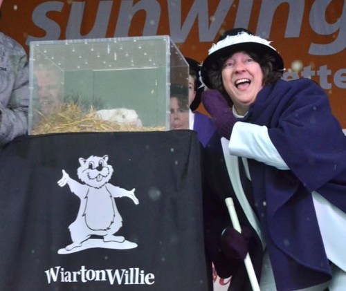 Mayor Janice Jackson takes a second message from Wiarton Willie, in Wiarton, Ont., on February 2, 2020. Groundhog Day will be observed online across Canada today in the interest of public safety during the ongoing COVID-19 pandemic. Ontario's Wiarton Willie and Nova Scotia's Shubenacadie Sam will make their annual predictions in front of no crowds, instead the critters' emergence from their homes will be broadcast. THE CANADIAN PRESS/Doug Ball