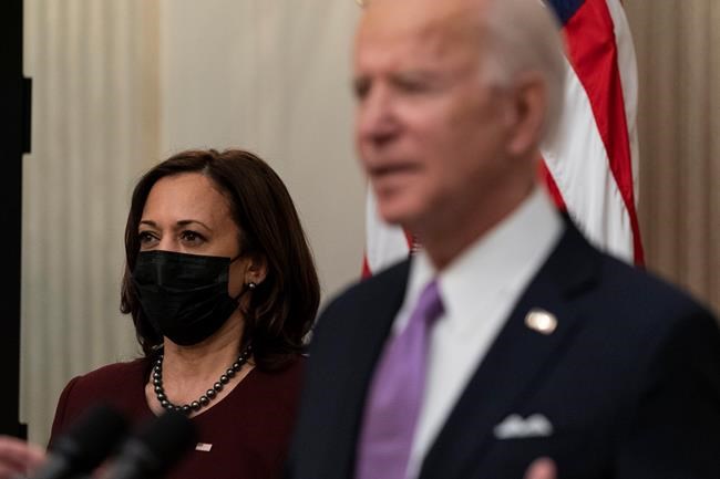Vice President Kamala Harris, left, listens as President Joe Biden speaks about the coronavirus, in the State Dinning Room of the White House on January 21, 2021, in Washington. THE CANADIAN PRESS/AP, Alex Brandon