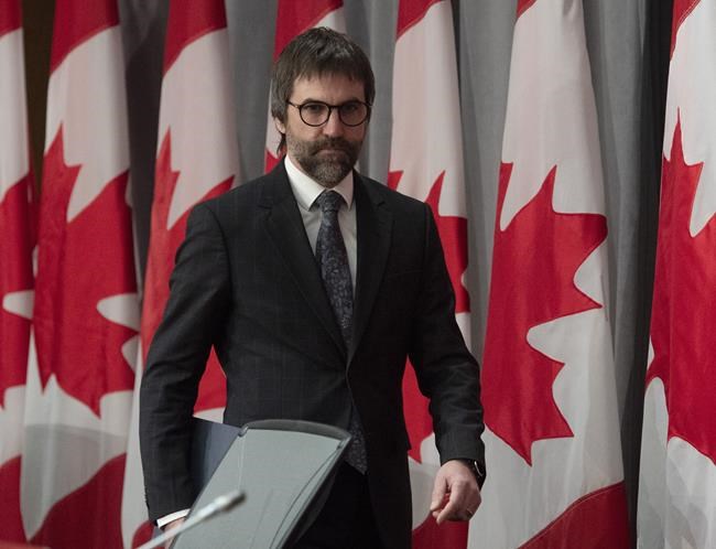 Minister of Canadian Heritage Steven Guilbeault makes his way to his seat for a news conference in Ottawa, Friday, April 17, 2020. THE CANADIAN PRESS/Adrian Wyld