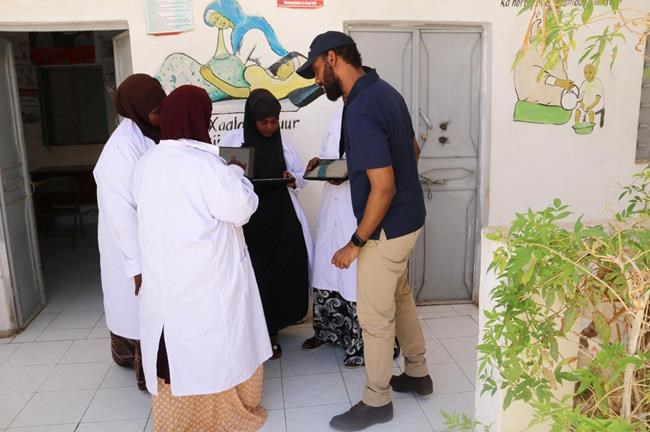 Canadian Khalid Hashi, right, shows videos about COVID-19 in his app OGOW EMR in Garowe, Puntland, Somalia, to front-line nurses and health-care workers in an undated handout photo. Before Hashi created the app, which contains information in Somali and Arabic about the novel coronavirus, Somalia only had public health messages about COVID-19 in English. THE CANADIAN PRESS/HO-Khalid Hashi, *MANDATORY CREDIT*