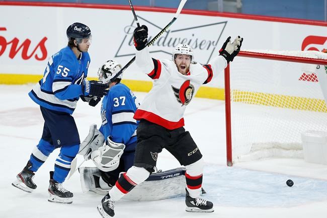 Ottawa Senators' Chris Tierney (71) celebrates Brady Tkachukճ (7) game winning goal against Winnipeg Jets goaltender Connor Hellebuyck (37) and Mark Scheifele (55) with 8.2 seconds left in third period NHL action in Winnipeg on Saturday, February 13, 2021. THE CANADIAN PRESS/John Woods