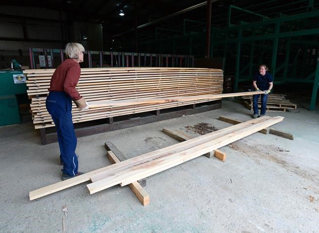 Workers sort wood at Murray Brothers Lumber Company woodlot in Madawaska, Ontario on Tuesday, April 25, 2017. Homebuyers and renovators hoping for a mid-winter price slump are instead being greeted with new all-time record high prices for lumber and oriented strandboard manufactured building panels. THE CANADIAN PRESS/Sean Kilpatrick