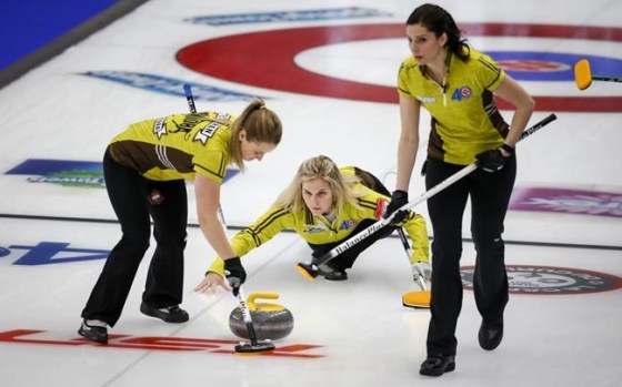 Team Manitoba skip Jennifer Jones makes her last shot against Team Saskatchewan as second Jocelyn Peterman, left, and lead Lisa Weagle sweep at the Scotties Tournament of Hearts in Calgary on February 22, 2021. THE CANADIAN PRESS/Jeff McIntosh