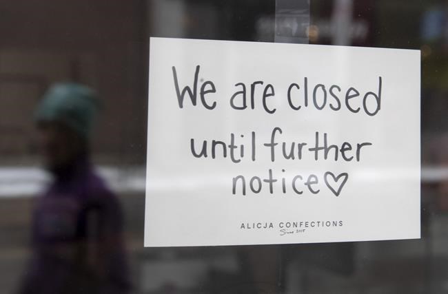 A sign on a shop window indicates the store is closed in Ottawa, Monday March 23, 2020. A new report says Canada’s small businesses now collectively owe more than $135 billion as they struggle to survive the pandemic, a staggering amount experts say could hurt the country's economic recovery.THE CANADIAN PRESS/Adrian Wyld