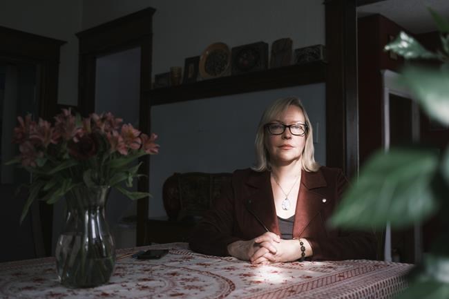 Jo-Anne Dusel, executive director of the Provincial Association of Transition Houses of Saskatchewan, poses for a photo at her home in Moose Jaw, Sask., on Thursday, Feb. 25, 2021. THE CANADIAN PRESS/Michael Bell