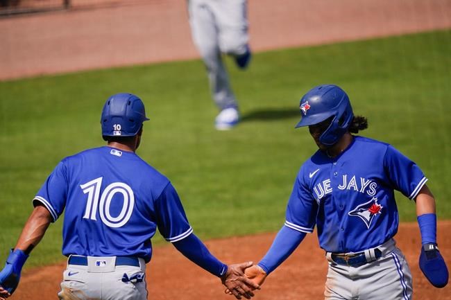 Toronto Blue Jays' Reese McGuire (10) celebrates with Bo Bichette, right, after Bichette scored on a two-run double by Rowdy Tellez during the first inning of a spring baseball game Sunday, Feb. 28, 2021, in Tampa, Fla. THE CANADIAN PRESS/AP, Frank Franklin II