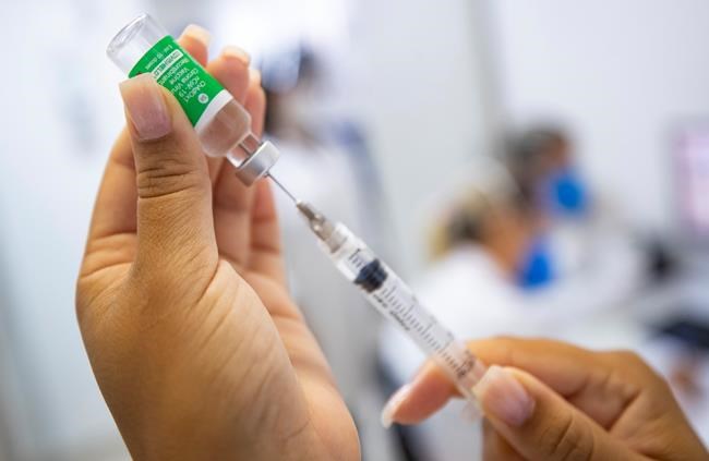 A nurse assistant prepares a dose of the Oxford-AstraZeneca vaccine for COVID-19 during a priority vaccination program for health workers at a community medical center in Sao Paulo, Brazil, Wednesday, Feb. 3, 2021. THE CANADIAN PRESS/AP-Andre Penner